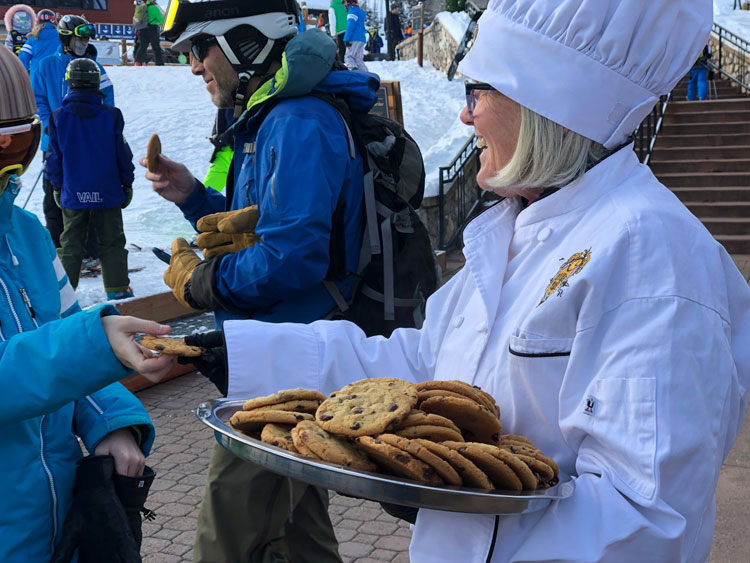 Enjoying warm chocolate chip cookies at Beaver Creek. Cookies combined with a great ski school and beginner terrain make this best ski resorts in Colorado for beginners.