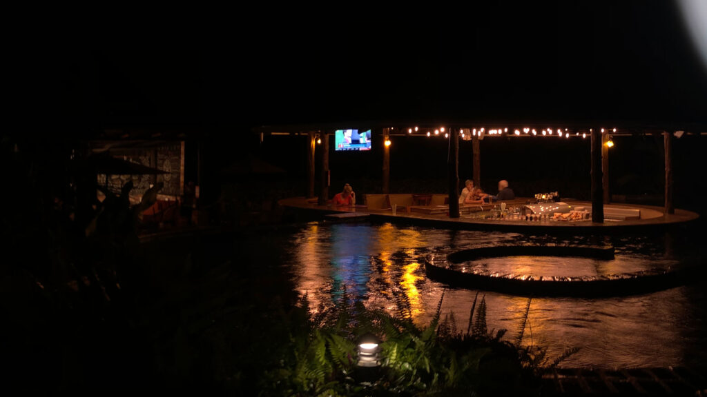 The thermal waters of the Arenal Manoa hot springs at night.