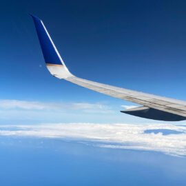 Essentials for Long Haul Flights view from airplane window of hawaii below